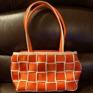 Small orange and white shoulder purse.